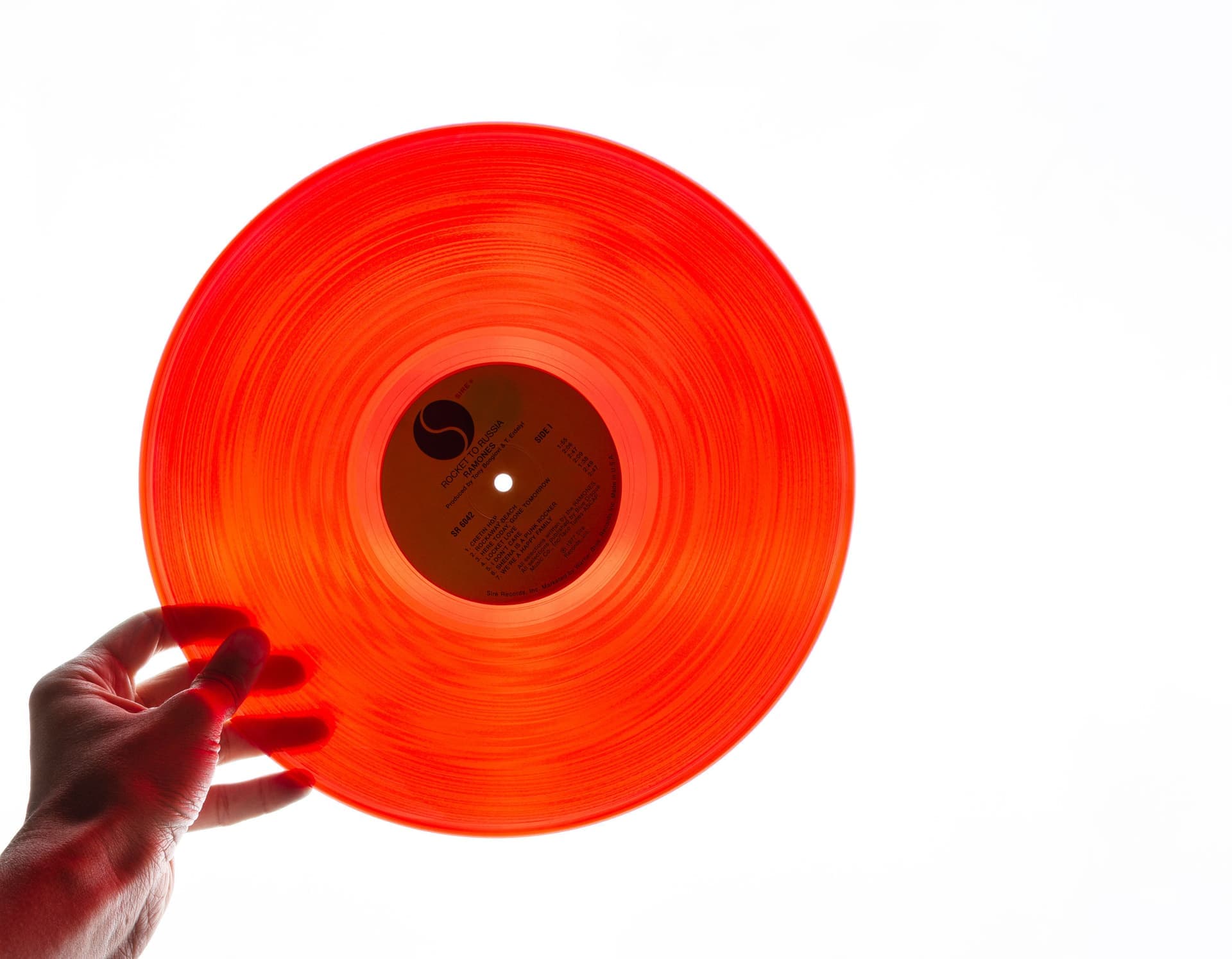 A vinyl record being cleaned with a soft brush